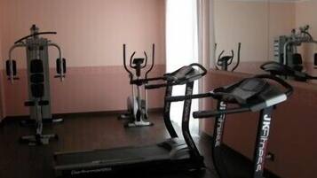 A gym with cardio equipment, including a treadmill and elliptical machines.