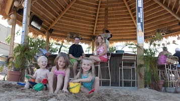 Enjoy a family-friendly atmosphere at this beachside pavilion, surrounded by lush greenery and perfect for relaxation.