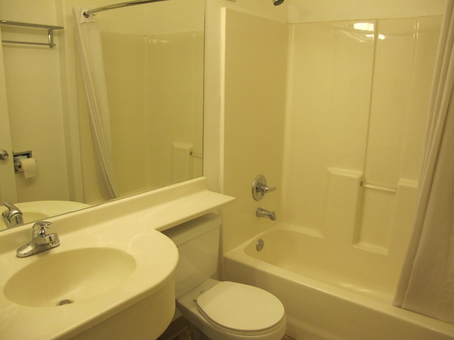 A bathroom with a sink, toilet, and bathtub.