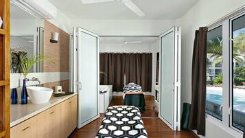 Relax in a serene space with a bathtub, reading nook, and expansive outdoor views.