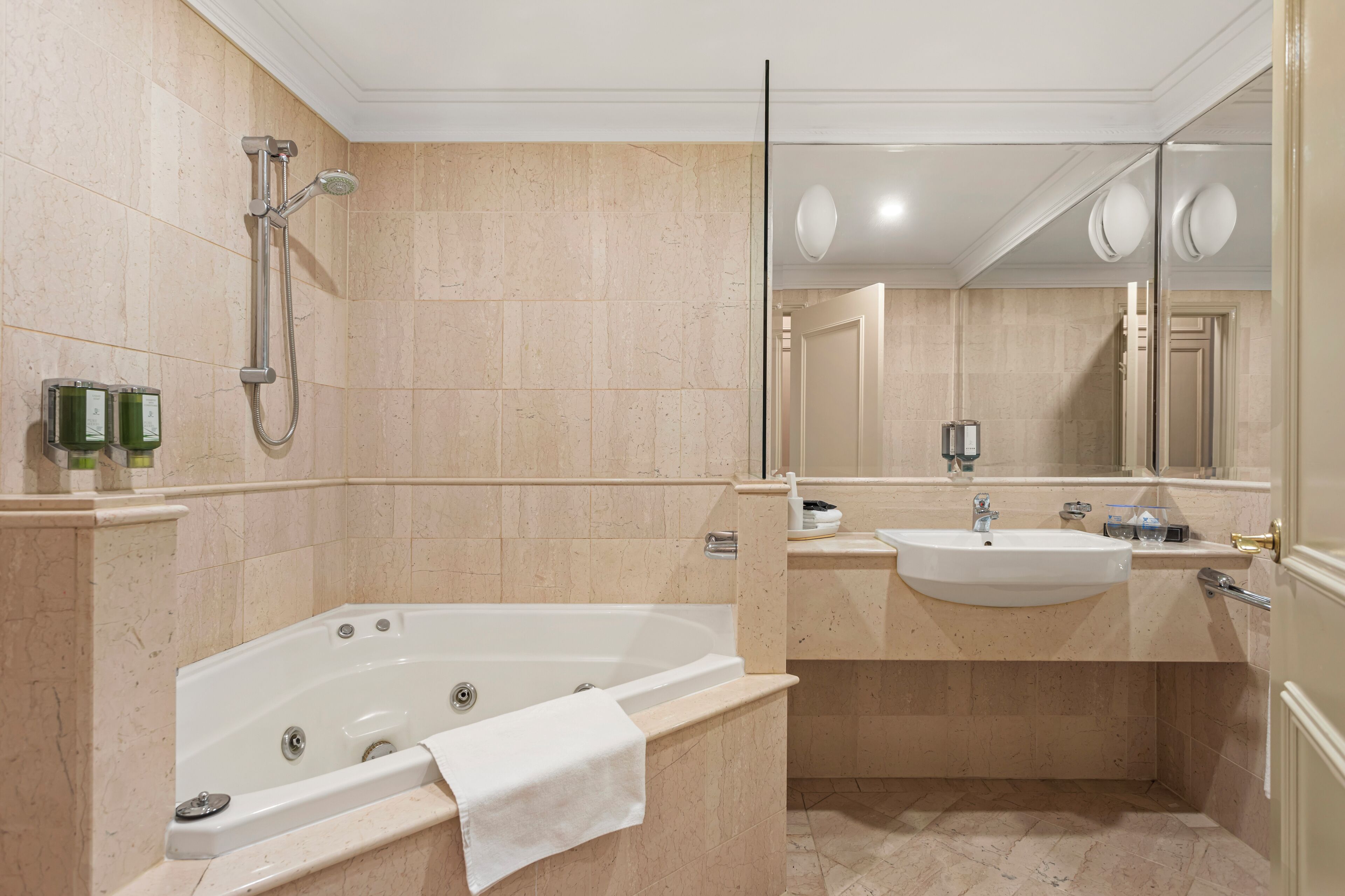 A modern bathroom with a freestanding bathtub, a sink, and a large mirror.