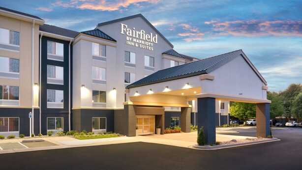 A Fairfield by Marriott Inn & Suites building with a covered entrance, multiple windows, and a parking lot. - Fairfield Inn by Marriott Lexington Park Patuxent River Naval Air Station (Lexington Park)