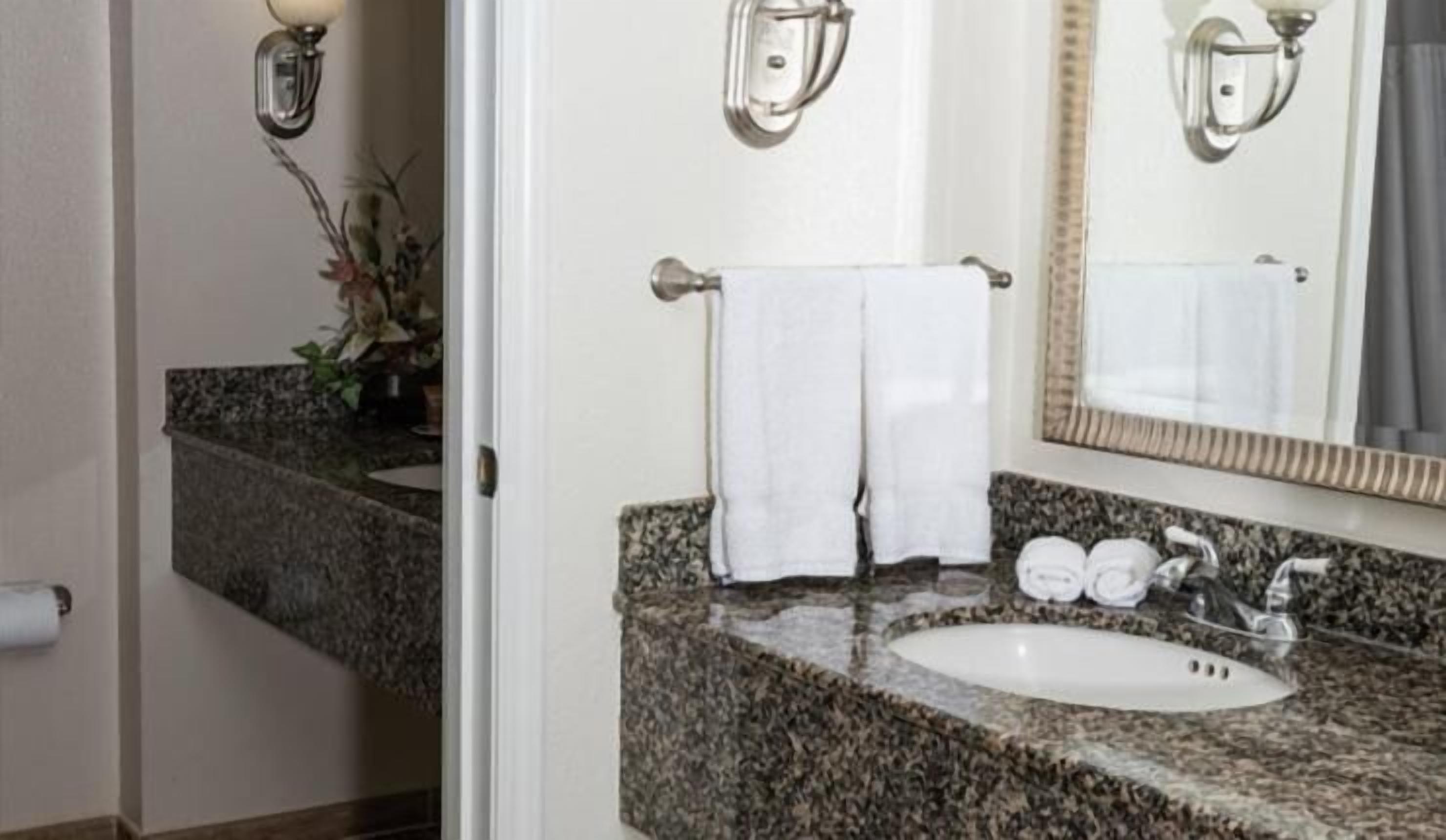 combined shower/bathtub, designer toiletries, hair dryer, towels