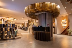 A hotel reception area with a modern design, including a circular light fixture and a reception desk. - Best Western Plus Congress Hotel (Yerevan)