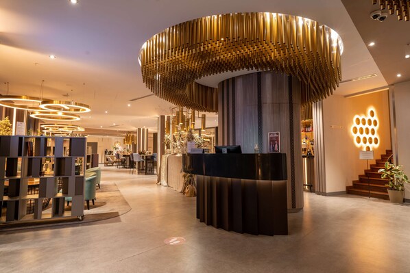 A hotel reception area with a modern design, including a circular light fixture and a reception desk. - Best Western Plus Congress Hotel (Yerevan)