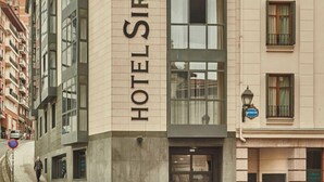 A hotel named 'HOTEL SIRIMI' with a modern facade, large windows, and a visible entrance. - Silken Sirimiri (Bilbao)