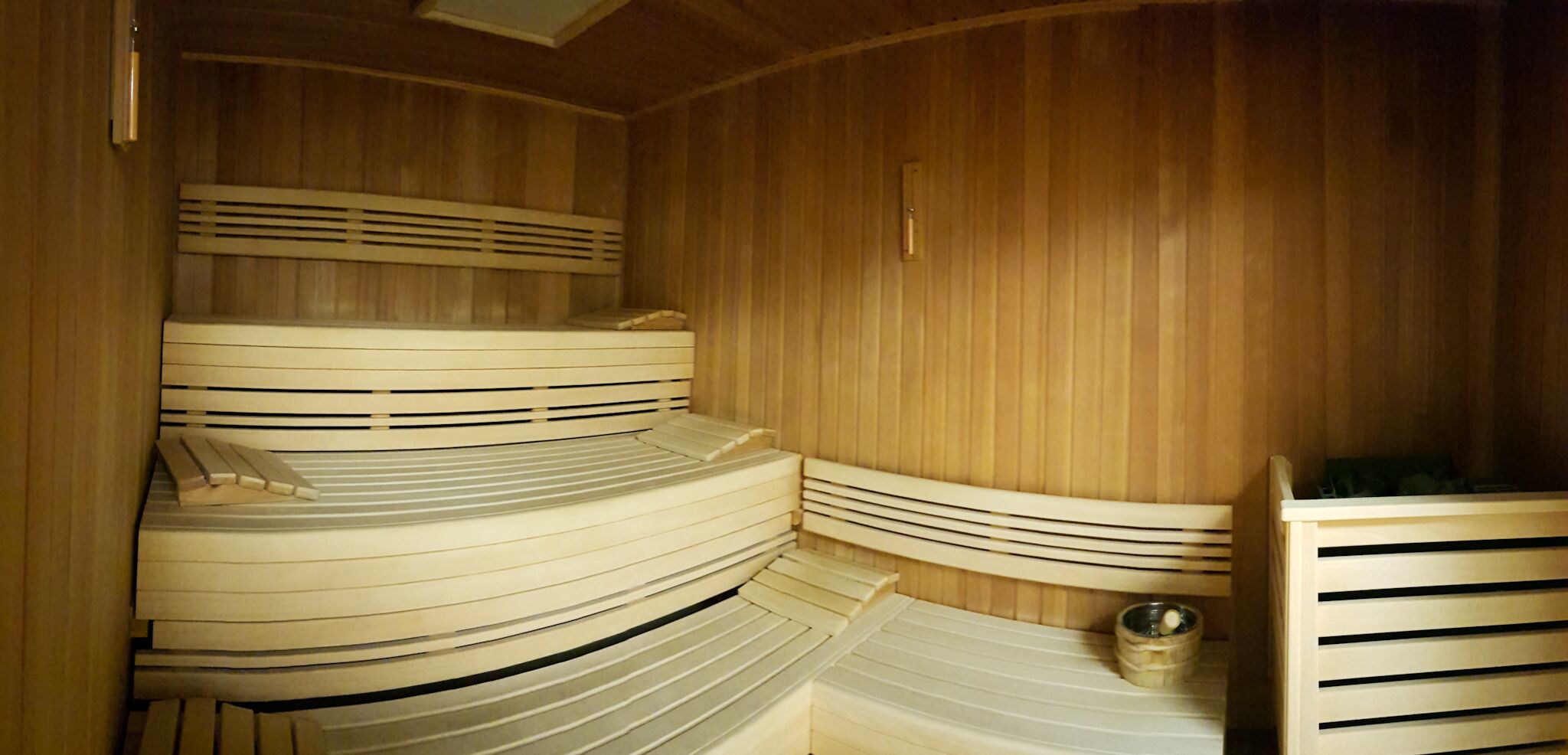 A sauna with wooden walls and benches.