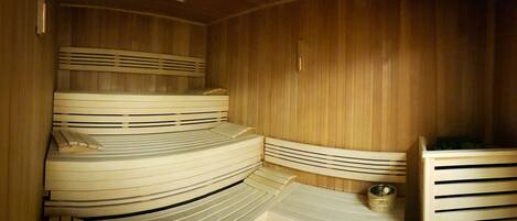 A sauna with wooden walls and benches.
