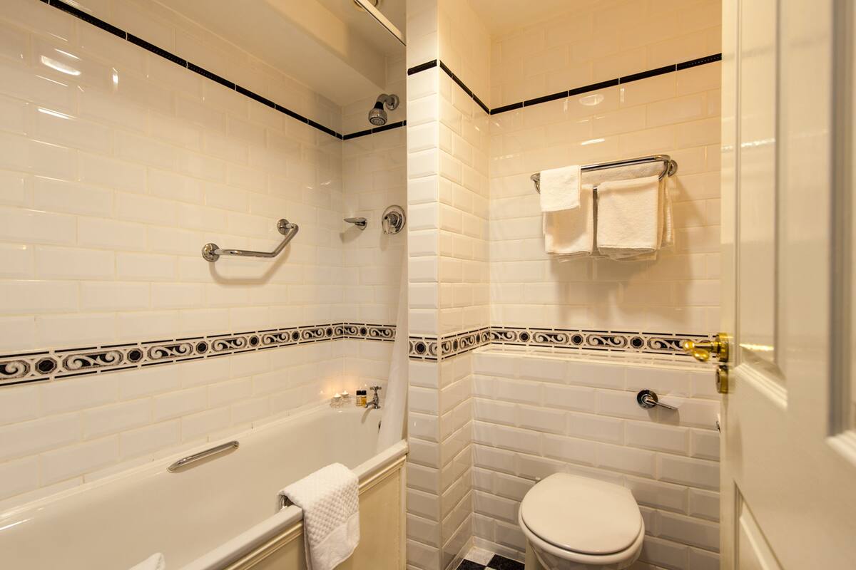standard twin room | bathroom | shower, rainfall showerhead, hair dryer, towels