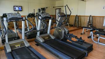 A gym with treadmills, ellipticals, and weight machines.