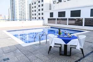Outdoor pool, open 10:00 AM to 7:00 PM, pool umbrellas, pool loungers