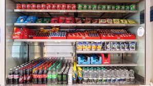 A refrigerated display case with various snacks, drinks, and packaged goods. - Holiday Inn Express London - Dartford by IHG (Dartford)