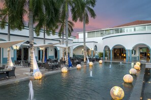 Relax in a serene courtyard with a tranquil water feature and outdoor seating areas.