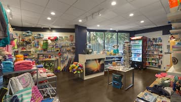 A brightly lit store with various children's items, including toys and clothing, displayed on shelves and tables.