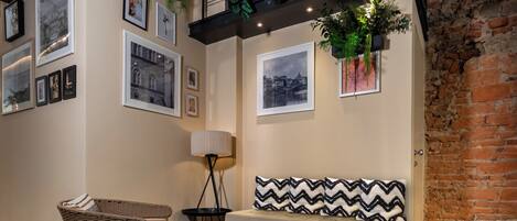 A cozy seating area with a bench, a wicker chair, and a floor lamp.