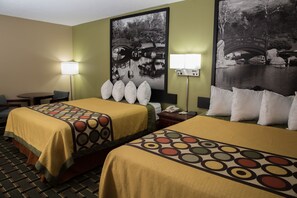 A hotel room with two beds, a desk, and a chair. There are two wall-mounted lamps and a large black and white photo of a bridge. - Econo Lodge Canton North (Canton)