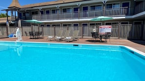 Outdoor pool, open 9 AM to 10 PM, pool umbrellas