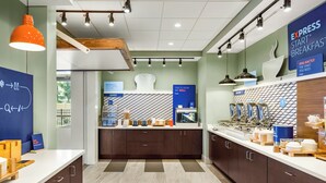 A modern breakfast area with a counter, seating, and a sign for 'EXPRESS START BREAKFAST'. - Holiday Inn Express & Suites Sanford- Lake Mary by IHG (Sanford)