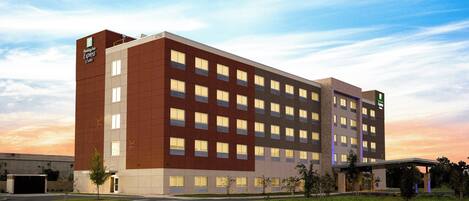 A large, multi-story hotel with a modern design, featuring a flat roof and a mix of brick and glass facade.