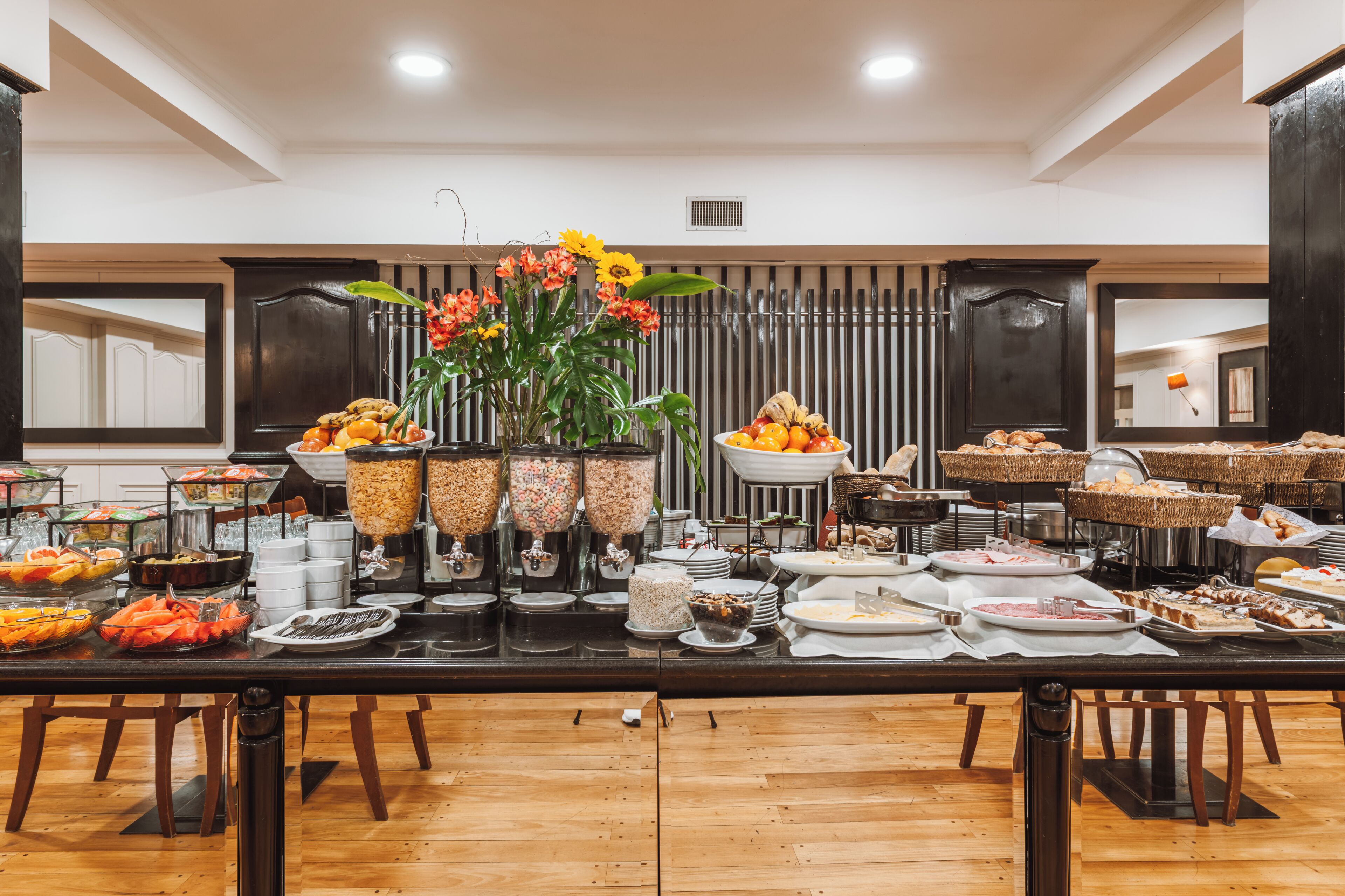 A buffet setup with various food items and a decorative centerpiece.