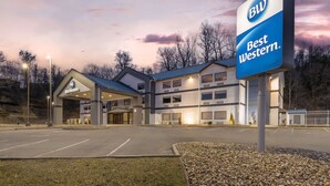 A Best Western hotel with a modern design, featuring a large sign, a parking lot, and a well-lit entrance. - Best Western River Cities (Russell)