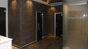 A modern interior with dark walls, a recessed ceiling, and a glass door with a nameplate. - Albergo Roma, BW Signature Collection (Castelfranco Veneto)
