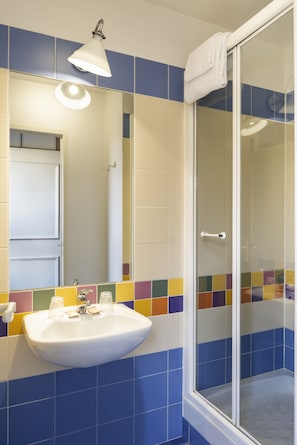 Bathtub, eco-friendly toiletries, hair dryer, towels