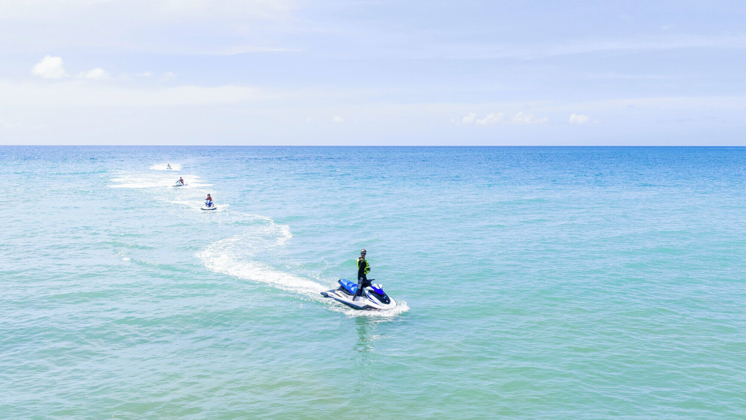 A jet ski on calm ocean waters with a clear sky.