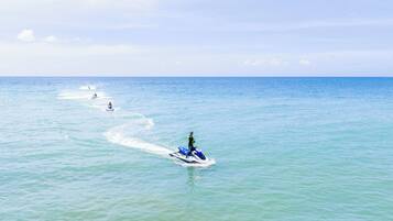 A jet ski on calm ocean waters with a clear sky.