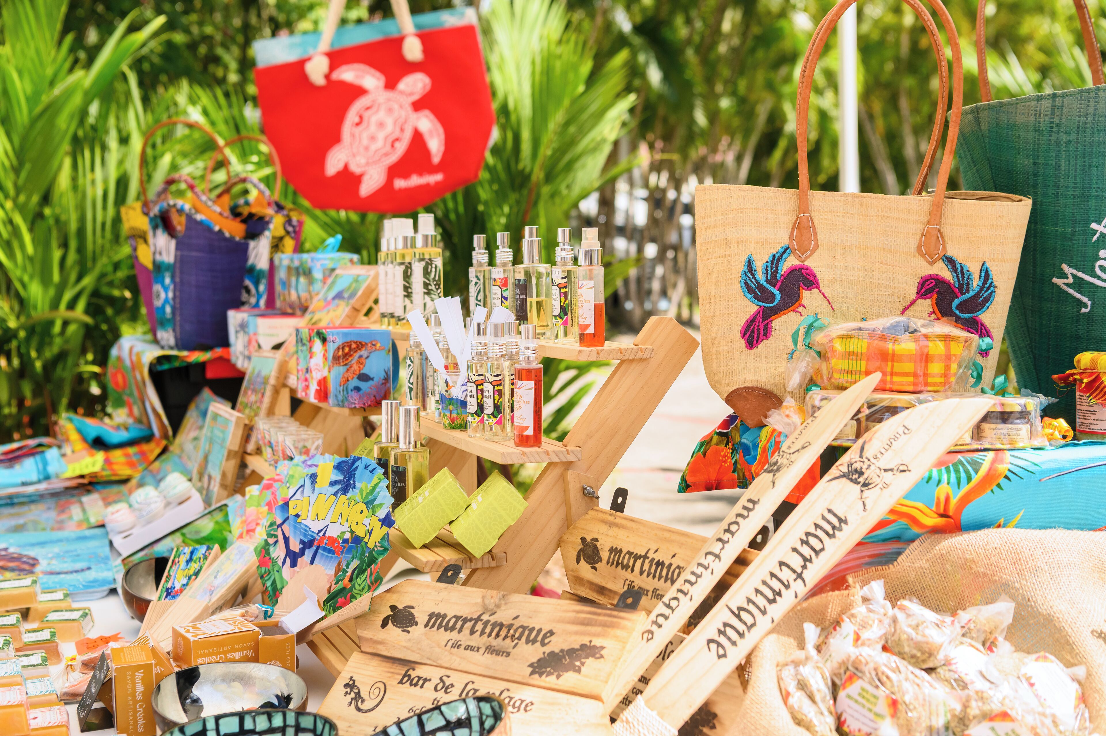 A market stall with various items including bags, bottles, and boxes.