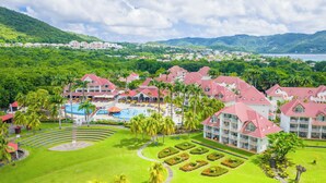 A resort with multiple buildings, a swimming pool, and lush greenery. - Village St Luce Pierre & Vacances (Sainte-Luce)
