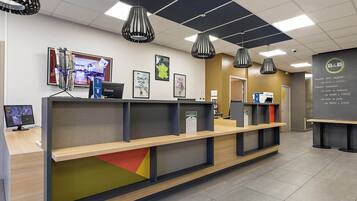 A reception desk with a computer, framed pictures, and a B&B logo.