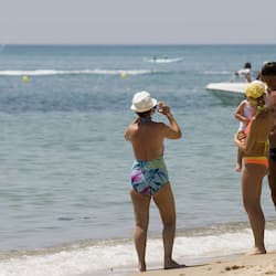 On the beach, white sand, sun loungers, beach umbrellas