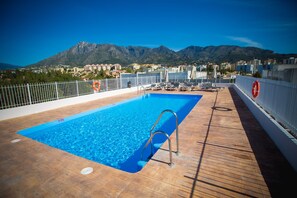 Relax by the rooftop pool with a scenic view of the surrounding mountains.