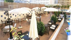 A rooftop patio with outdoor seating, umbrellas, and potted plants. - Hotel El Faro Marbella (Marbella)