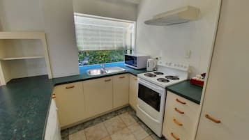 Fridge, microwave, electric kettle, cookware/dishes/utensils