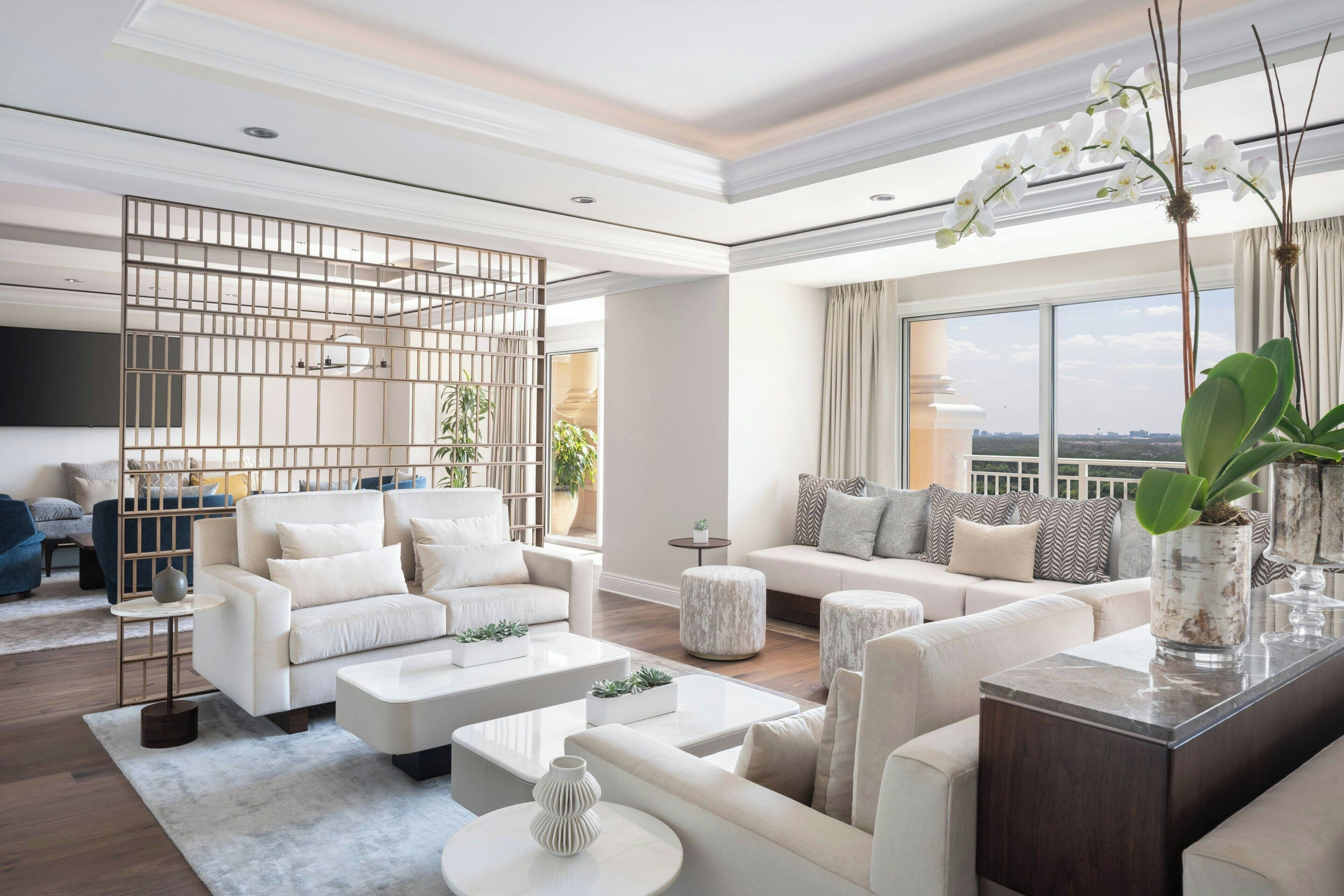 A modern living room with a sectional sofa, a coffee table, and a decorative plant.