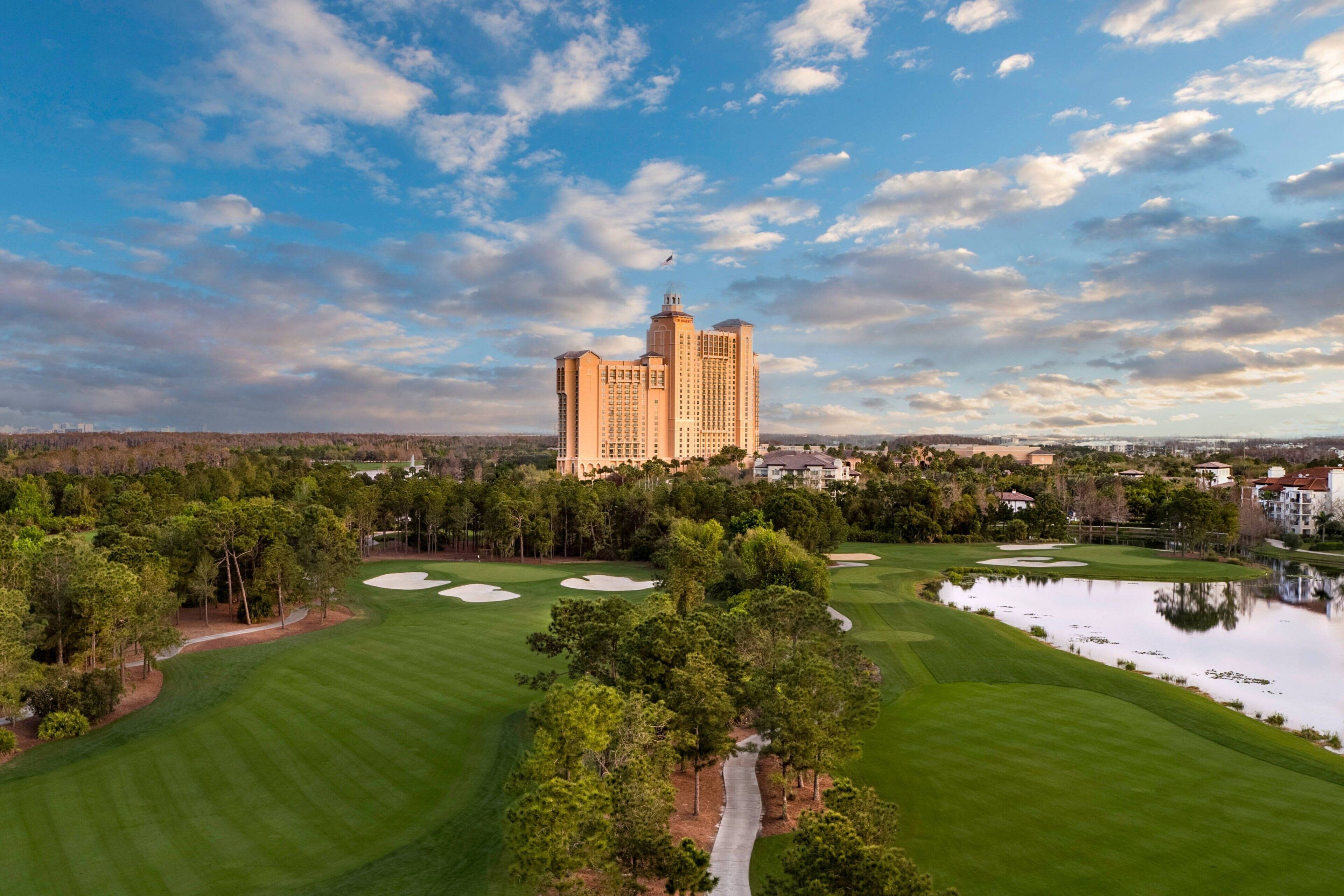 A golf course with a large building in the background.