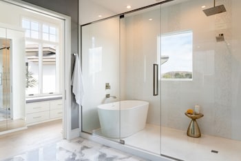 Separate tub and shower, designer toiletries, hair dryer, bathrobes at The Ritz-Carlton Orlando, Grande Lakes
