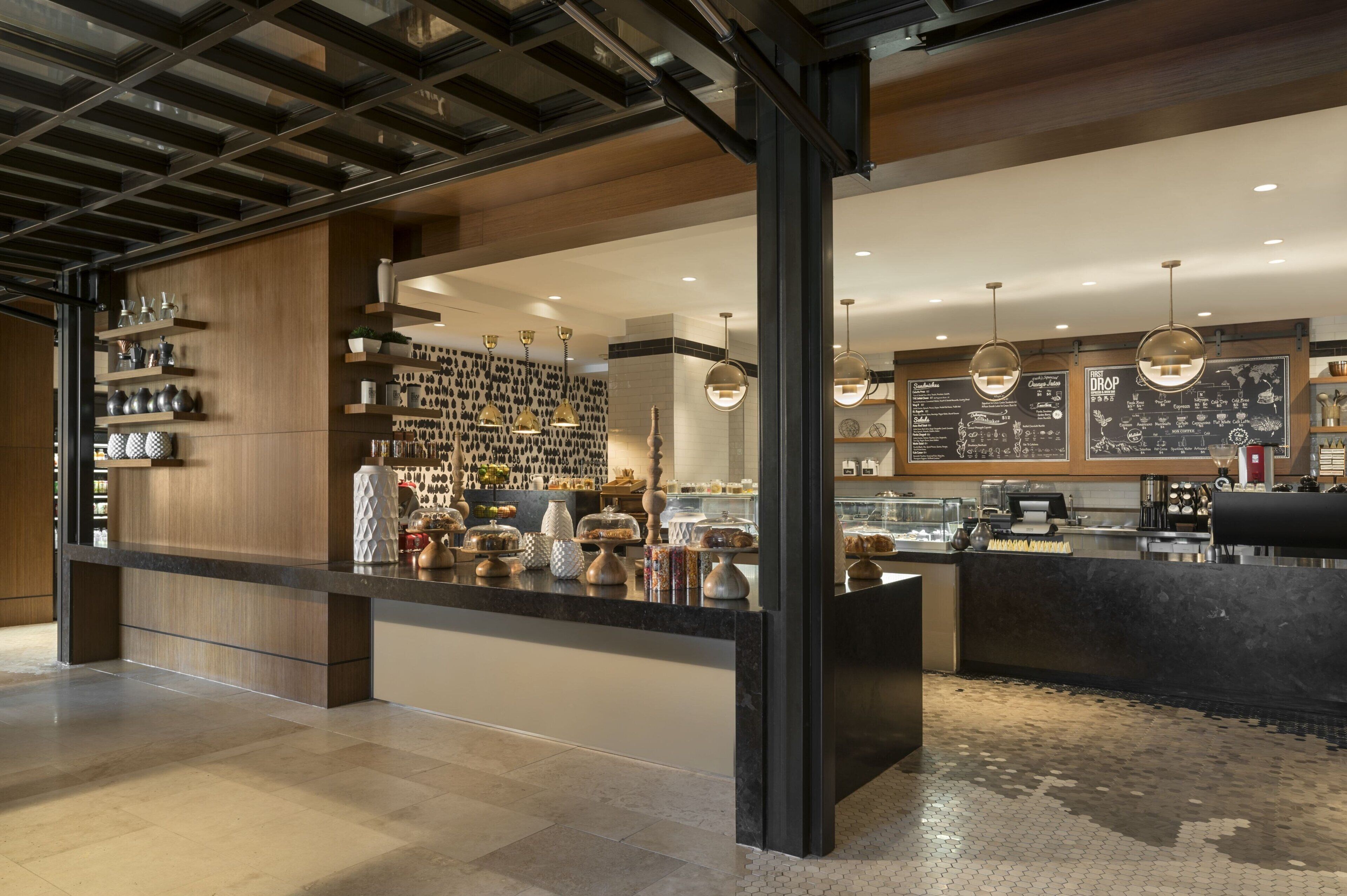 Ein modernes Café-Interieur mit einer Theke, die Gebäck anbietet, und einer Speisekarte.