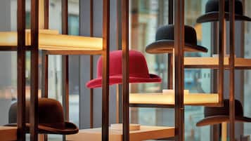 A display of hats on shelves with a cityscape view in the background.