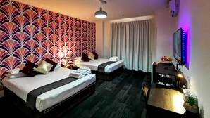 A hotel room with two beds, a desk, a TV, and a patterned wall. - Criterion Hotel Perth (Perth)