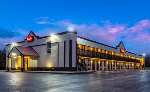 A Red Roof Inn with a two-story structure, a covered parking area, and a visible entrance. - Red Roof Inn Scottsburg (Scottsburg)