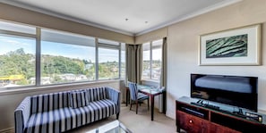 Premium Triple Room, Multiple Beds | Living area | 42-inch flat-screen TV with cable channels, TV