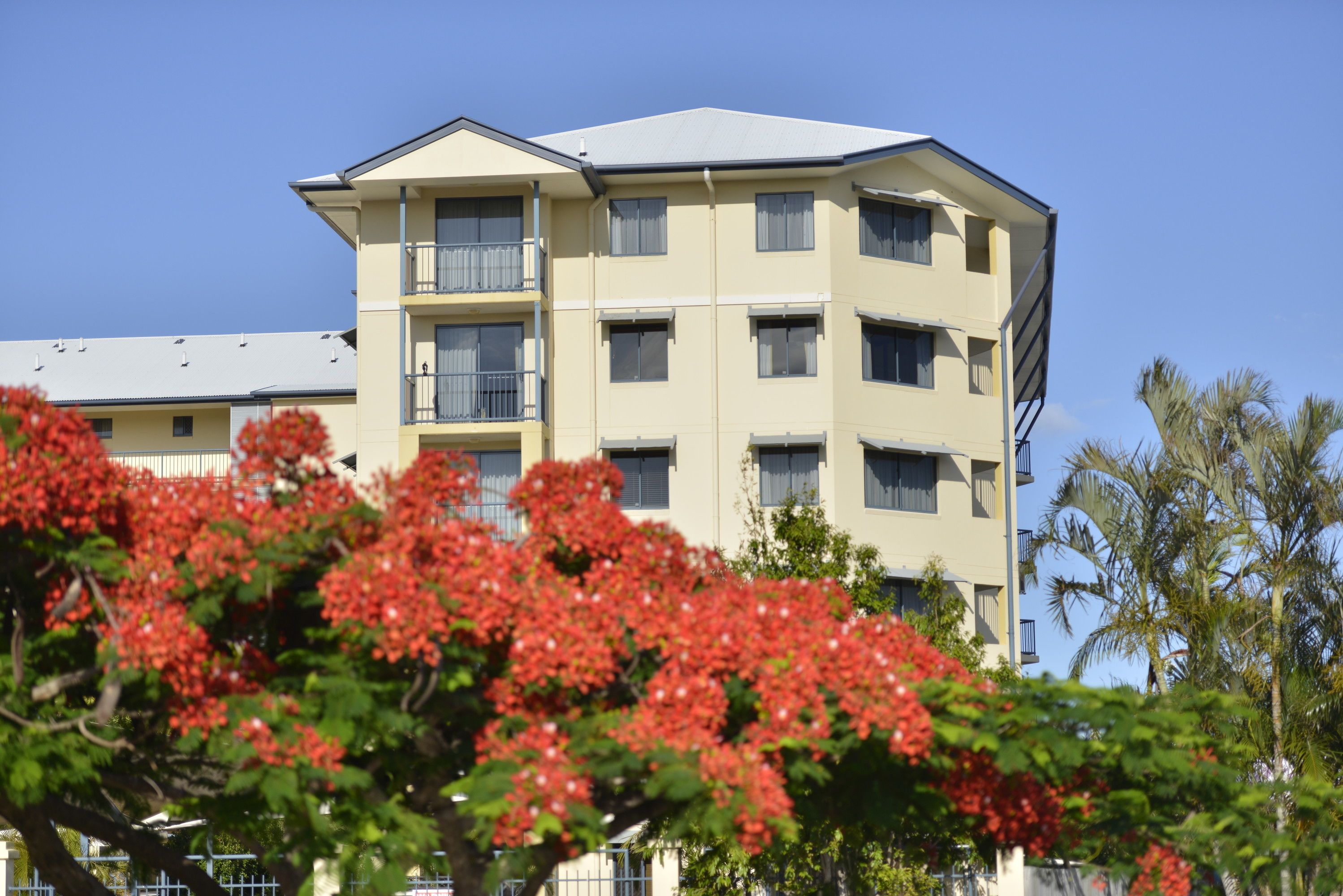 A multi-story hotel with balconies and a flat roof.