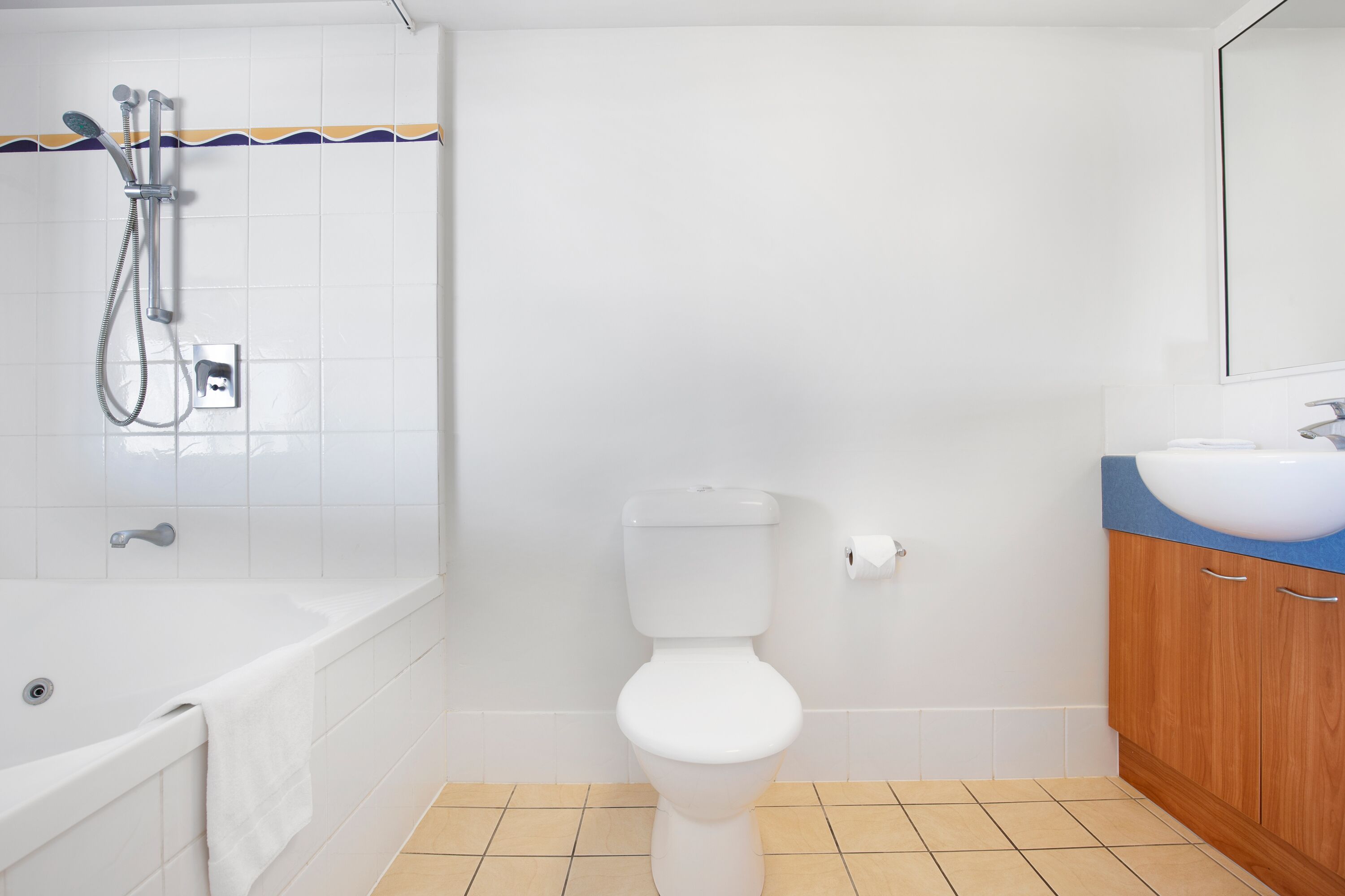 A bathroom with a white toilet, a bathtub, and a shower.