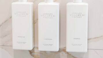 Three bottles of Lorenzo Villoresi Firenze products on a marble surface.