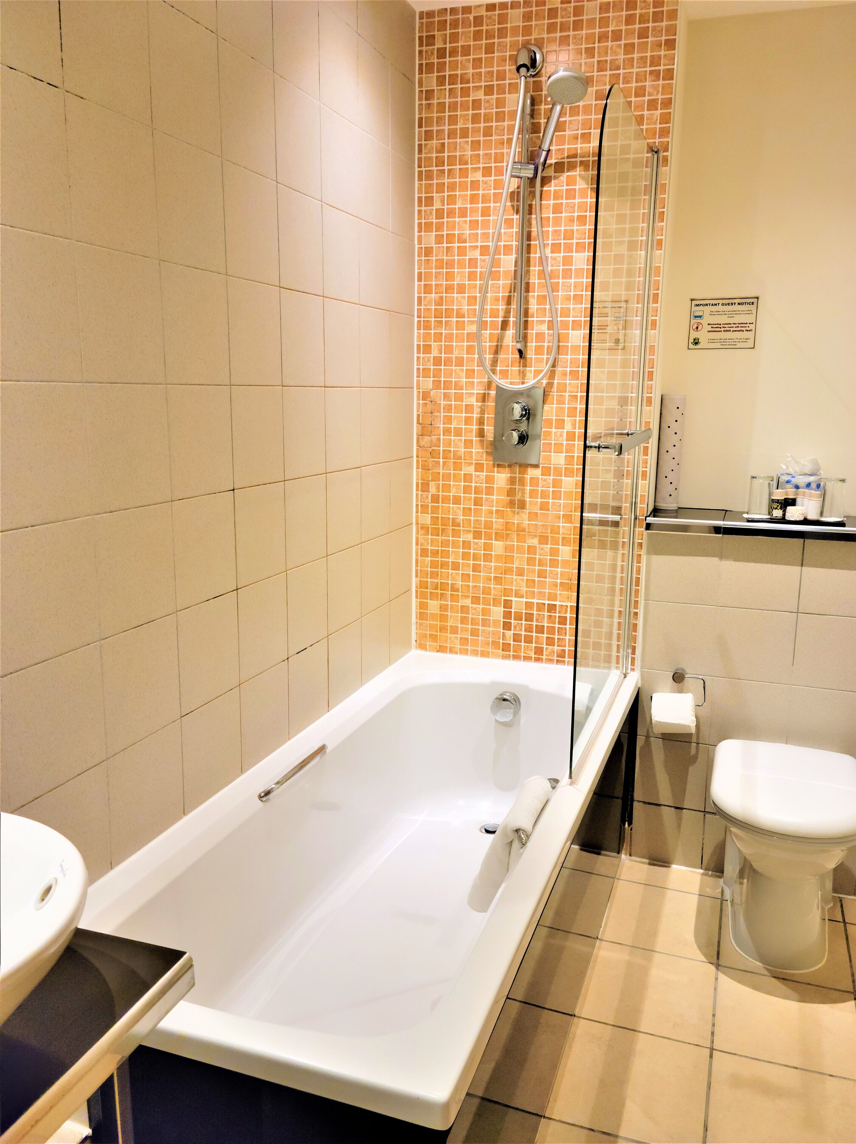 A bathroom with a bathtub, a shower, and a toilet.