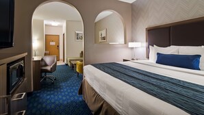 A hotel room with a bed, a desk, a chair, and a television. - Best Western Plus Tulsa Inn & Suites (Tulsa)