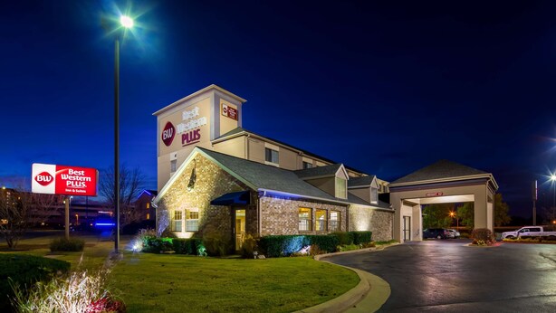 A Best Western Plus hotel with a brick facade, illuminated signage, and a well-lit entrance. - Best Western Plus Tulsa Inn & Suites (Tulsa)